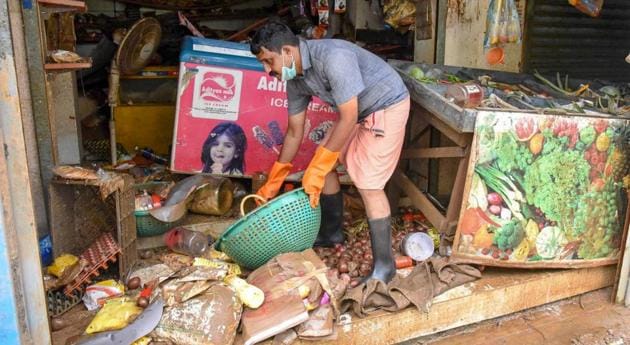 A man salvages the items at his shop after flood water receded at North Paravoor in Kochi on August 20, 2018.(PTI)