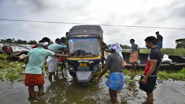 Local residents help each other in taking out vehicles from a boat in Alappuzha district. Train services which had collapsed following the incessant downpour in Kerala, have been partially restored, reports ANI. (Raj K Raj / HT Photo) Local residents help each other in taking out vehicles from a boat in Alappuzha district. Train services which had collapsed following the incessant downpour in Kerala, have been partially restored, reports ANI. (Raj K Raj / HT Photo)