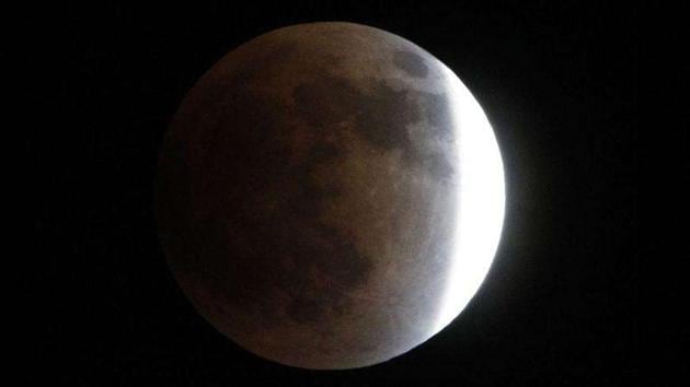 The Earth casts its shadow across the moon's surface during the lunar eclipse in Tokyo.(AP Photo) The Earth casts its shadow across the moon's surface during the lunar eclipse in Tokyo.(AP Photo)