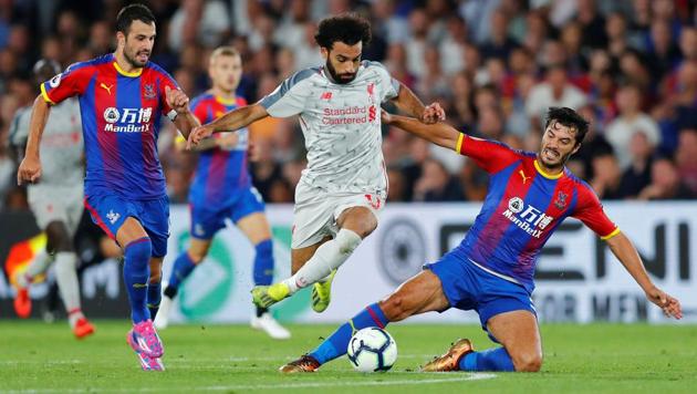 Liverpool's Mohamed Salah in action with Crystal Palace's James Tomkins and Luka Milivojevic.(REUTERS)