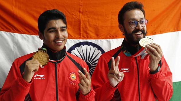 Gold medallist Saurabh Chaudhary of India and bronze medallist Abhishek Verma of India hold up their medals.(REUTERS)