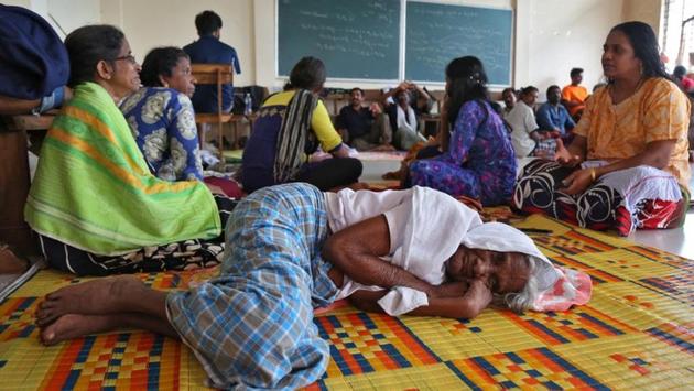 Flood victims rest inside a university classroom, which is converted into a temporary relief camp in Kochi on August 18, 2018. Though rains have subsided, stagnant water remains as there in no outlet. Those in camps are battling hunger, disease and poor hygiene. Large scale disinfection of flood-hit areas is being carried out. (Sivaram V / REUTERS) Flood victims rest inside a university classroom, which is converted into a temporary relief camp in Kochi on August 18, 2018. Though rains have subsided, stagnant water remains as there in no outlet. Those in camps are battling hunger, disease and poor hygiene. Large scale disinfection of flood-hit areas is being carried out. (Sivaram V / REUTERS)