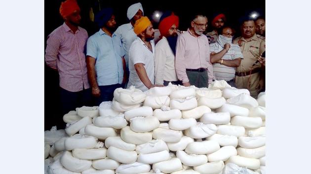 A health department team with the seized paneer in Ballomajra, Mohali, on Tuesday.(HT Photo)