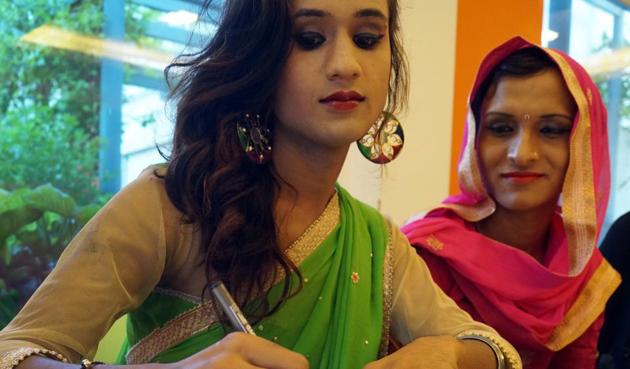 A transgender who has been working as a dancer and a make-up artist in Uttar Pradesh signs a letter that will be sent to the Prime Minister, along with a rakhi.(Gokul V.Shime/HT)