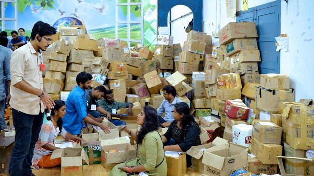 Student volunteers manage and take stock of packed relief material for flood victims at a relief material collection centre in Trivandrum, Kerala.(AFP Photo)