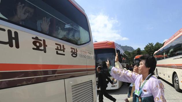 North Koreans wave to their South Korean relatives on a bus to bid farewell after the separated family reunion meeting at the Diamond Mountain resort in North Korea on Wednesday.(AP Photo) North Koreans wave to their South Korean relatives on a bus to bid farewell after the separated family reunion meeting at the Diamond Mountain resort in North Korea on Wednesday.(AP Photo)