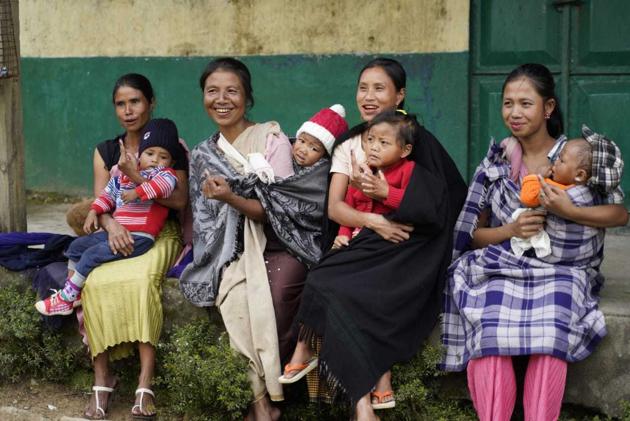 Women with children on piggy back after casting their votes at a polling station in Ranikor constituency. (HT Photo) Women with children on piggy back after casting their votes at a polling station in Ranikor constituency. (HT Photo)