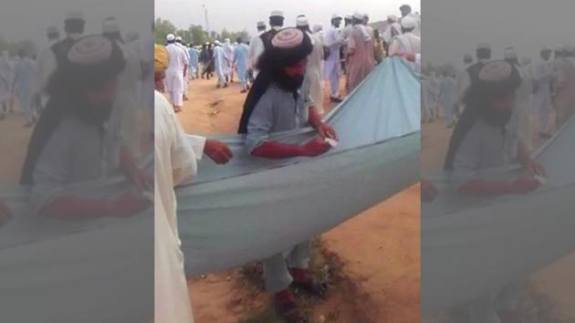In one video, two men are holding up a sheet of cloth containing a sizeable amount of cash as a third man, speaking in a mix of Urdu and Pashto, asks people attending the Eid prayers to contribute for the ‘jihad by Muslims’ against the ‘kafir’ forces in America and India. (Photo: Facebook) In one video, two men are holding up a sheet of cloth containing a sizeable amount of cash as a third man, speaking in a mix of Urdu and Pashto, asks people attending the Eid prayers to contribute for the ‘jihad by Muslims’ against the ‘kafir’ forces in America and India. (Photo: Facebook)