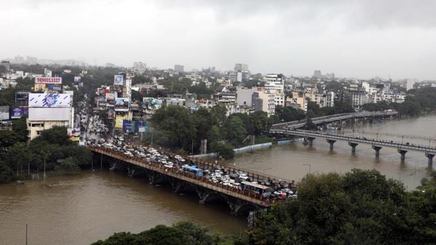 A view of the swollen Mutha river after 18,491 cusecs of water was released from Khadakwasla dam into the river on Tuesday. Water level has increased in all the rivers in the city due to continuous rainfall. (RAHUL RAUT/HT PHOTO) 