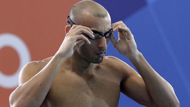 India's Virdhawal Vikram Khade prepares to swim in his heat of the men's 100m freestyle during swimming competition.(AP)