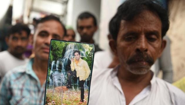 Shahrukh’s father Istikar holds up an old photo of his son. He is survived by a wife and an infant son. (Sonu Mehta/HT Photo) Shahrukh’s father Istikar holds up an old photo of his son. He is survived by a wife and an infant son. (Sonu Mehta/HT Photo)