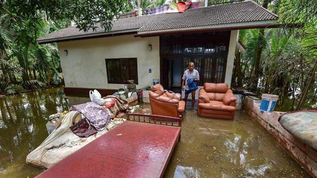 A man cleans up his house after flood water subsided, in Puthenvelikkara near Kochi on Wednesday, Aug 22, 2018.(PTI)