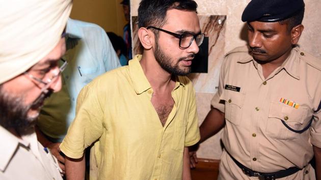 Delhi police officials with JNU student Umar Khalid who escaped unhurt after an unidentified man shot at him, outside the Constitution club at Rafi Marg in Central Delhi.(HT File Photo) Delhi police officials with JNU student Umar Khalid who escaped unhurt after an unidentified man shot at him, outside the Constitution club at Rafi Marg in Central Delhi.(HT File Photo)