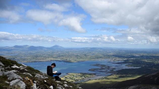 A young pilgrim reads on Croagh Patrick holy mountain during an annual Catholic pilgrimage. “He’s still preaching the same gospel as they’ve all been preaching. He’s just got a little more understanding of the present way people are feeling,” Towell said. (Clodagh Kilcoyne / REUTERS) A young pilgrim reads on Croagh Patrick holy mountain during an annual Catholic pilgrimage. “He’s still preaching the same gospel as they’ve all been preaching. He’s just got a little more understanding of the present way people are feeling,” Towell said. (Clodagh Kilcoyne / REUTERS)