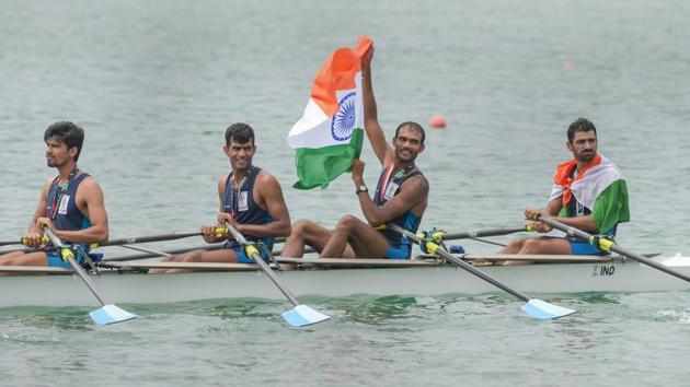 Indian rowing Men's team members Sawarn Singh, Bhokanal Dattu, Om Prakash and S Singh Quadruple Sculls with national flag celebrate after the medal ceremony winning the gold medal during the 18th Asian Games.(PTI)