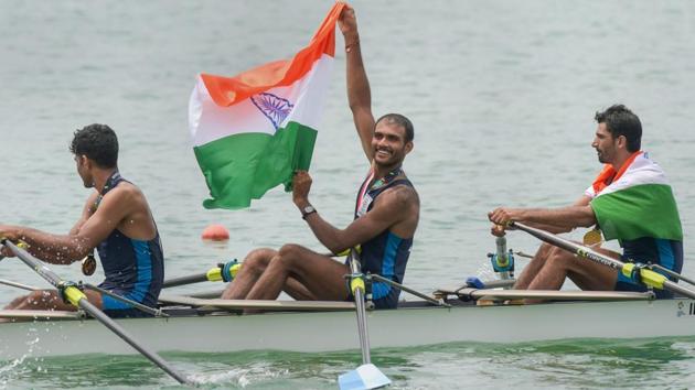 Palembang: Indian rowing Men's team member Bhokanal Dattu holds the national flag as he celebrates after the medal ceremony winning the gold medal Men's Quadruple Sculls. (PTI) Palembang: Indian rowing Men's team member Bhokanal Dattu holds the national flag as he celebrates after the medal ceremony winning the gold medal Men's Quadruple Sculls. (PTI)