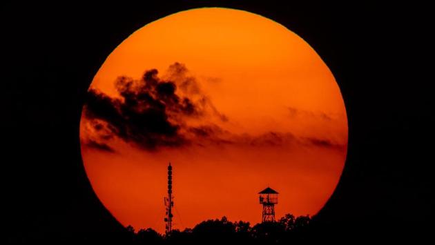 The setting sun frames a look-out tower and a telecommunication transmission tower near Salgotarjan, some 100km northeast of Budapest, Hungary. (Peter Komka / MTI via AP)