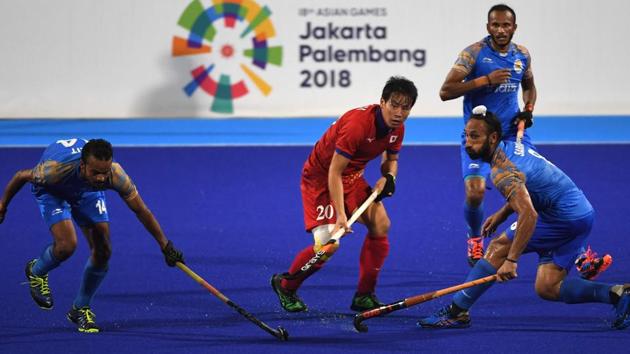 India's Lalit Kumar Upadhyay (L) and Japan's Masaki Ohashi (C) compete for the ball during the men's hockey pool B match. (AFP) India's Lalit Kumar Upadhyay (L) and Japan's Masaki Ohashi (C) compete for the ball during the men's hockey pool B match. (AFP)