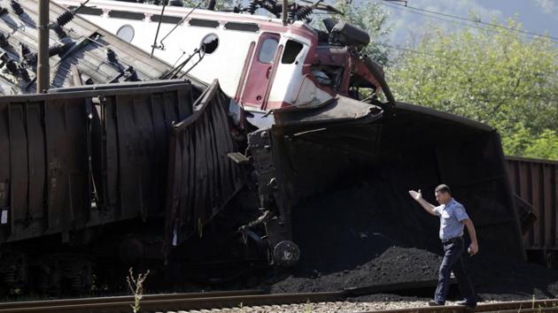 A police officer walks near the site where two cargo trains collided at the train station in Jablanica, about 80 kms south of Sarajevo, Bosnia. (Amel Emric / AP)