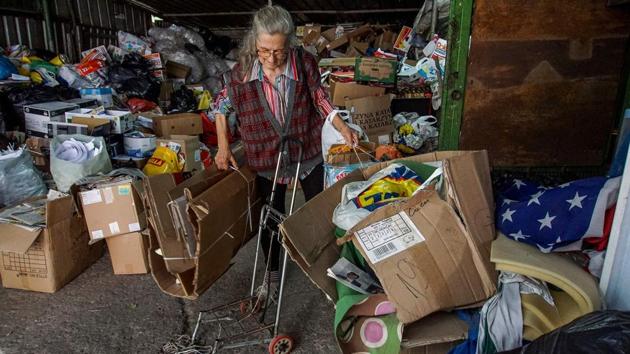 Penka unloads cardboard at a local recycling depot. “Seven days a week, 2.50 leva (1.25 euros) per day makes around 20 leva per week but I am grateful,” the haggard woman told AFP outside the depot, clutching her daily haul of coins in her hand. In recent years, people like Penka have become a common sight in the capital of the EU’s poorest member state. (Nikolay Doychinov / AFP)