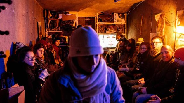 An artist performs indoors for theatre-goers. “We collect, separate like ants -- to earn our living. But I think we are also doing good. If that ends, I’ll put out a hand, if someone drops something in it...” a 60-year-old recycler shrugged as he turned in a huge pile of refuse paper to earn his wage for the day. (Dimitar Dilkoff / AFP)