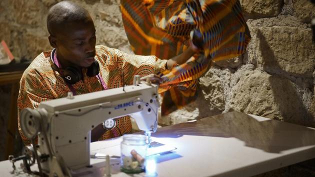 Daouda Doumbia, 26, from Ivory Coast, works at The Sewing Cooperative nonprofit organization, in Rome, Italy. An American costume maker living in Rome has created this dressmaking cooperative around migrant tailors, an example of initiatives cropping up in Italy to help new arrivals assimilate and make a living while they wait for decisions on their asylum requests. (Andrew Medichini / AP) Daouda Doumbia, 26, from Ivory Coast, works at The Sewing Cooperative nonprofit organization, in Rome, Italy. An American costume maker living in Rome has created this dressmaking cooperative around migrant tailors, an example of initiatives cropping up in Italy to help new arrivals assimilate and make a living while they wait for decisions on their asylum requests. (Andrew Medichini / AP)