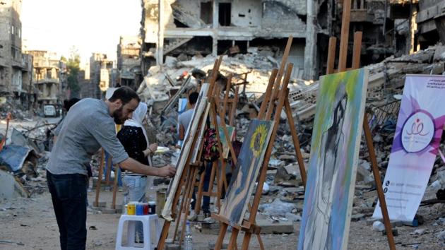One painting depicted streams of red running down a dark building and in another; an emaciated man was curled up naked in the foetal position. Visiting the camp last month, UNRWA commissioner-general Pierre Krahenbuhl said he had rarely seen such damage. “The scale of the destruction in Yarmuk compares to very little else that I have seen in many years of humanitarian work in conflict zones,” he said. (Maher Al Mounes / AFP)