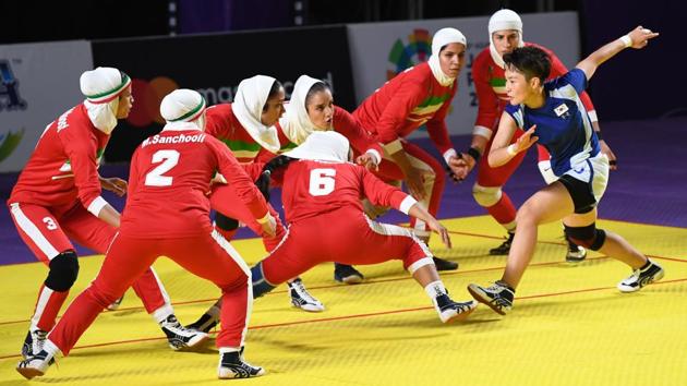 A South Korean player (R-in blue) tries to score as Iran players (in red) defend during the women’s team Group B kabaddi match between Iran and South Korea at the 2018 Asian Games in Jakarta, Indonesia. (Aamir Qureshi / AFP)
