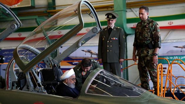 Iranian President Hassan Rouhani (L) sits in the cockpit of the “Kowsar” domestic fighter jet, at the National Defence Industry exhibition in the capital Tehran. Iran unveiled its first domestic jet, a fourth-generation fighter, with “advanced avionics” and multi-purpose radar, which the local Tasnim news agency said was “100-percent indigenously made”. (Iranian Presidency / Handout / AFP)