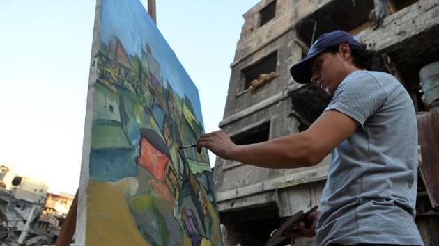 Equipped with paint brushes and pencils, around 12 young artists were seen with their easels in the once-crowded camp turned Damascus suburb, now largely abandoned after seven years of civil war. They set out to translate suffering into art in a neighbourhood ravaged by years of bombardment and siege. (Maher Al Mounes / AFP)
