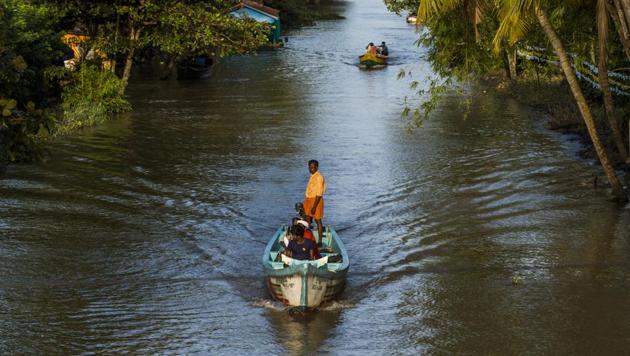 People ride boats past houses partially submerged in floodwaters in Kainakary village in the district of Alappuzha, Kerala. At least 265 people have been killed since August 8, when a week-long bout of heavy rains began, and the state government said assets worth Rs 19,500 crore had been destroyed as floods washed away homes, roads and bridges.(Bloomberg Photo) People ride boats past houses partially submerged in floodwaters in Kainakary village in the district of Alappuzha, Kerala. At least 265 people have been killed since August 8, when a week-long bout of heavy rains began, and the state government said assets worth Rs 19,500 crore had been destroyed as floods washed away homes, roads and bridges.(Bloomberg Photo)