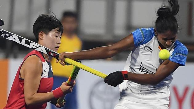 India's Lilima Minz (R) fights for ball with South Korea's player during the women's hockey pool B match between India and South Korea. (AFP)