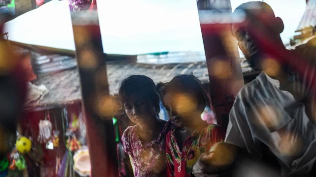Young Rohingya refugees are pictured by a jewellery display shelf in the Thengkhali camp. The district of Cox’s Bazar now hosts around one million Rohingya, the vast majority of whom fled their country a year ago, the Muslim minority branded back home as “Bengali” intruders. (Chandan Khanna / AFP) Young Rohingya refugees are pictured by a jewellery display shelf in the Thengkhali camp. The district of Cox’s Bazar now hosts around one million Rohingya, the vast majority of whom fled their country a year ago, the Muslim minority branded back home as “Bengali” intruders. (Chandan Khanna / AFP)