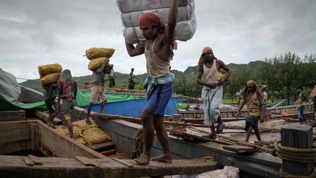 Rohingya workers transfer ginger, as others (front) load products from Bangladesh onto boats travelling to and from Myanmar’s Rakhine state. In June the World Bank moved to head off angst between the Rohingya and their Bangladeshi hosts, offering nearly half a billion dollars in grants for refugee health, education and sanitation. The aim is to help ease Dhaka’s burden and establish services that will also be used -- and staffed by -- Bangladeshis. (Ed Jones / AFP) Rohingya workers transfer ginger, as others (front) load products from Bangladesh onto boats travelling to and from Myanmar’s Rakhine state. In June the World Bank moved to head off angst between the Rohingya and their Bangladeshi hosts, offering nearly half a billion dollars in grants for refugee health, education and sanitation. The aim is to help ease Dhaka’s burden and establish services that will also be used -- and staffed by -- Bangladeshis. (Ed Jones / AFP)