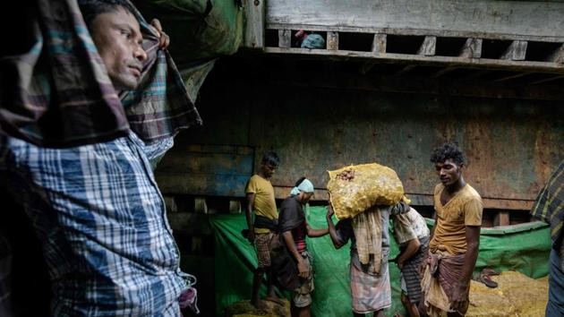 The refugee influx has been good for business, said his friend Thoin Line, an ethnic Rakhine importer from the Bangladesh side of the border. “The Rohingya are tough... they work night and day,” he says, adding, “and their wages are not too high.” Below, a line of drenched, wiry workers emerge from the hull of the boat, each shouldering two 30-kilogramme (66-pound) sacks of ginger imported from Myanmar. (Ed Jones / AFP) The refugee influx has been good for business, said his friend Thoin Line, an ethnic Rakhine importer from the Bangladesh side of the border. “The Rohingya are tough... they work night and day,” he says, adding, “and their wages are not too high.” Below, a line of drenched, wiry workers emerge from the hull of the boat, each shouldering two 30-kilogramme (66-pound) sacks of ginger imported from Myanmar. (Ed Jones / AFP)