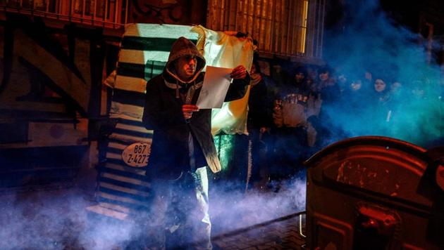 An artist during a performance organized by environmental pressure group Za Zemiata and the Vox Populi documentary theatre group in Sofia, Bulgaria. In a neighbourhood in downtown Sofia, theatregoers are looking for entertainment among the city’s rubbish -- quite literally. As night falls, spectators are led from one garbage bin to another, listening to the untold stories of the Bulgarian capital’s army of unofficial refuse collectors. (Dimitar Dilkoff / AFP)