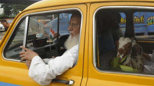 A shared ride in one of Kolkata’s iconic yellow cabs as people shop at a livestock market in Khiderpur ahead of Eid al-Adha in Kolkata, West Bengal. (Samir Jana / HT Photo) A shared ride in one of Kolkata’s iconic yellow cabs as people shop at a livestock market in Khiderpur ahead of Eid al-Adha in Kolkata, West Bengal. (Samir Jana / HT Photo)
