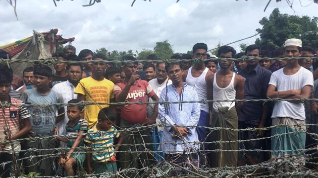 Rohingya refugees gather near the fence in the "no man's land" zone between Myanmar and Bangladesh border as seen from Maungdaw, Rakhine state during a government-organized visit for journalists on August 24, 2018. (AFP) Rohingya refugees gather near the fence in the "no man's land" zone between Myanmar and Bangladesh border as seen from Maungdaw, Rakhine state during a government-organized visit for journalists on August 24, 2018. (AFP)
