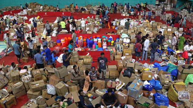 Volunteers at an aid distribution centre inside a stadium in Kochi, Kerala, August 19 (REUTERS)