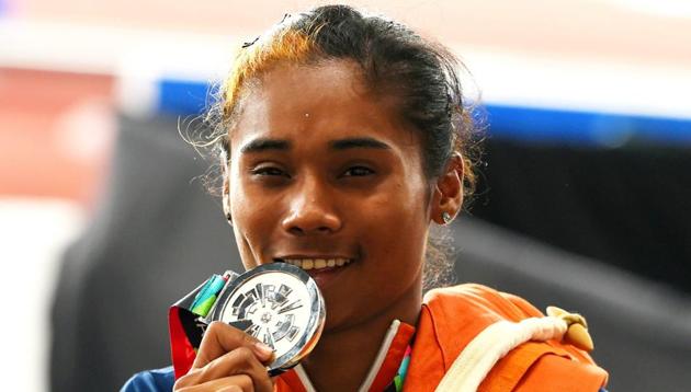 Jakarta: Indian athlete Hima Das celebrates after securing silver medal in the women's 400m final on Athletics track event at the 18th Asian Games 2018 in Jakarta, Indonesia on Sunday, Aug 26, 2018. (PTI Photo/Shahbaz Khan) (PTI8_26_2018_000191B)(PTI)