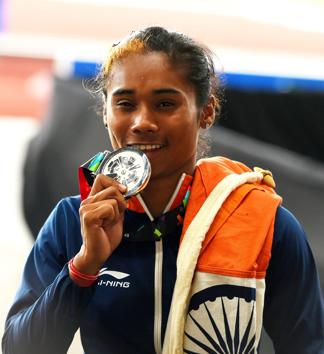 Indian athlete Hima Das celebrates after securing silver medal in the women's 400m final on Athletics track event at the 18th Asian Games 2018. (PTI) Indian athlete Hima Das celebrates after securing silver medal in the women's 400m final on Athletics track event at the 18th Asian Games 2018. (PTI)