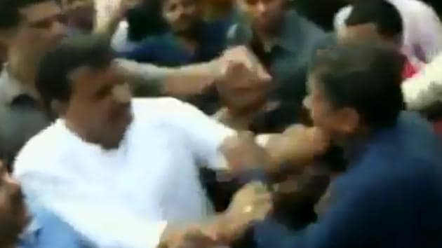 Congress MLA Umang Singhar (in white shirt) seen attacking a BJP leader in Dhar on August 25.(ANI/Screengrab)