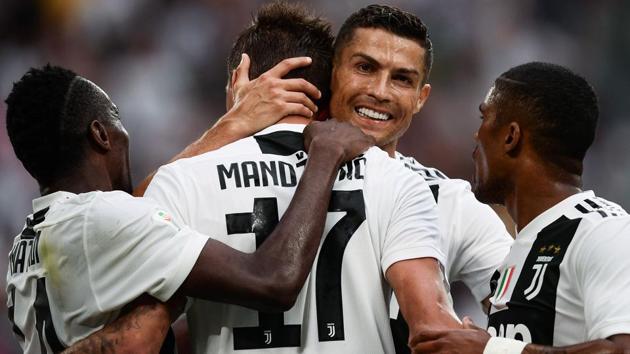 Juventus' Cristiano Ronaldo (2ndR) celebrates with his teammates during their Serie A match against Lazio.(AFP)