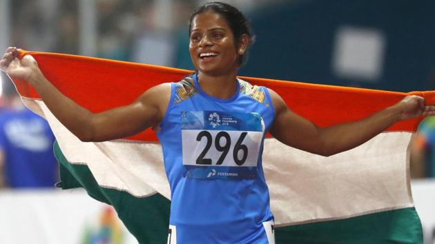 India's Dutee Chand celebrates after her second place finish in the women's 100m final during the athletics competition. (AP) India's Dutee Chand celebrates after her second place finish in the women's 100m final during the athletics competition. (AP)