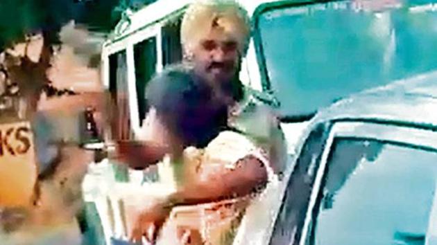 A video grab shows a cop assaulting the woman. (HT Photo) A video grab shows a cop assaulting the woman. (HT Photo)