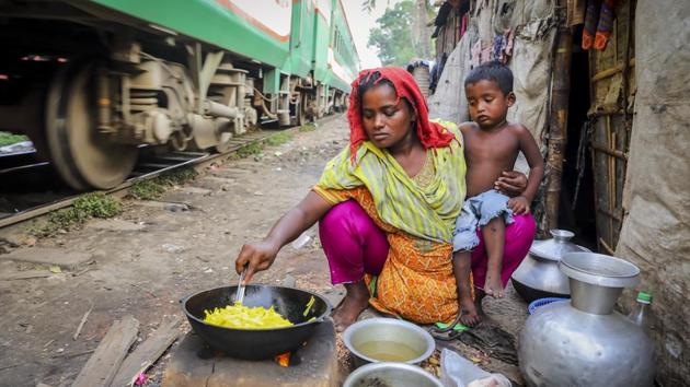 Rita Begum’s life in a slum in Dhaka is more perilous than back in North Bengal by the banks of the Brahmaputra where she endured annual floods. Losing an infant daughter to floodwaters in 2010, her husband brought her to Dhaka after her mental health deteriorated following the birth of a son six years later. Here, while he plies a rickshaw, she worries about the frequent trains and her son’s safety. (GMB Akash)