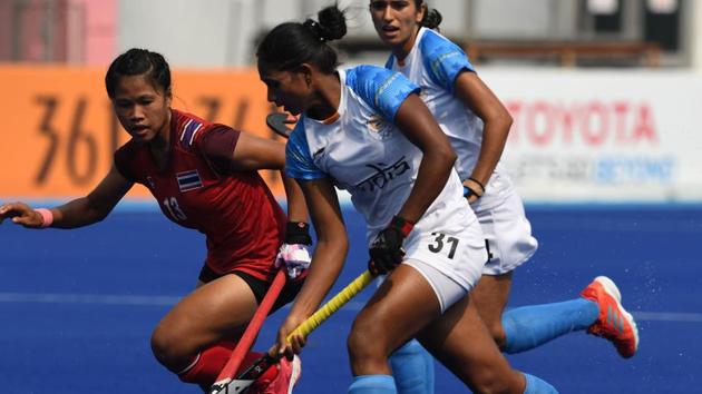 India's Lilima Minz (C) controls the ball past Thailand's Supanasa Samanso (L) during the women's hockey pool B match. (AFP) 