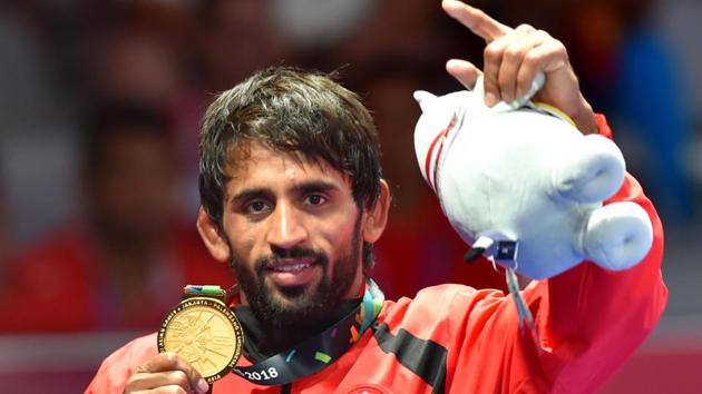 India's Bajrang Punia poses with his gold medal after winning in the Finals of men's freestyle wrestling (65kg) at Asian Games 2018.(PTI) India's Bajrang Punia poses with his gold medal after winning in the Finals of men's freestyle wrestling (65kg) at Asian Games 2018.(PTI)