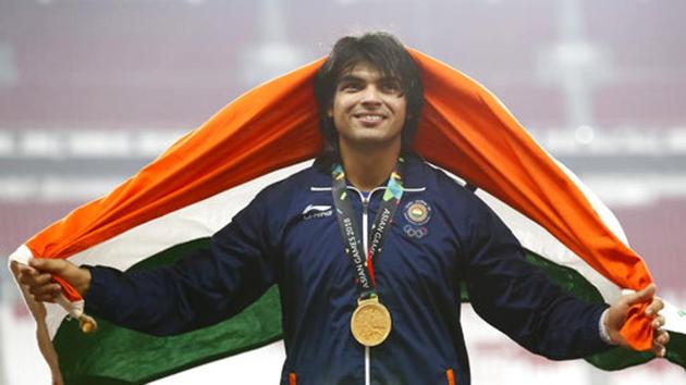 Men's javelin gold medallist India's Neeraj Chopra smiles as he stands on the podium during the athletics competition at the 18th Asian Games. (AP)