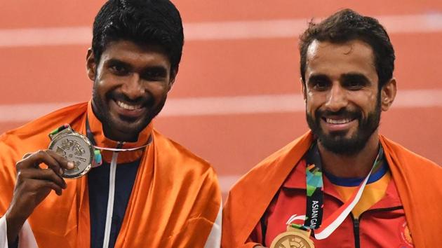 (L-R) Silver medallist India's Jinson Johnson and gold medallist India's Manjit Singh celebrate during the victory ceremony for the men's 800m athletics. (AFP) (L-R) Silver medallist India's Jinson Johnson and gold medallist India's Manjit Singh celebrate during the victory ceremony for the men's 800m athletics. (AFP)
